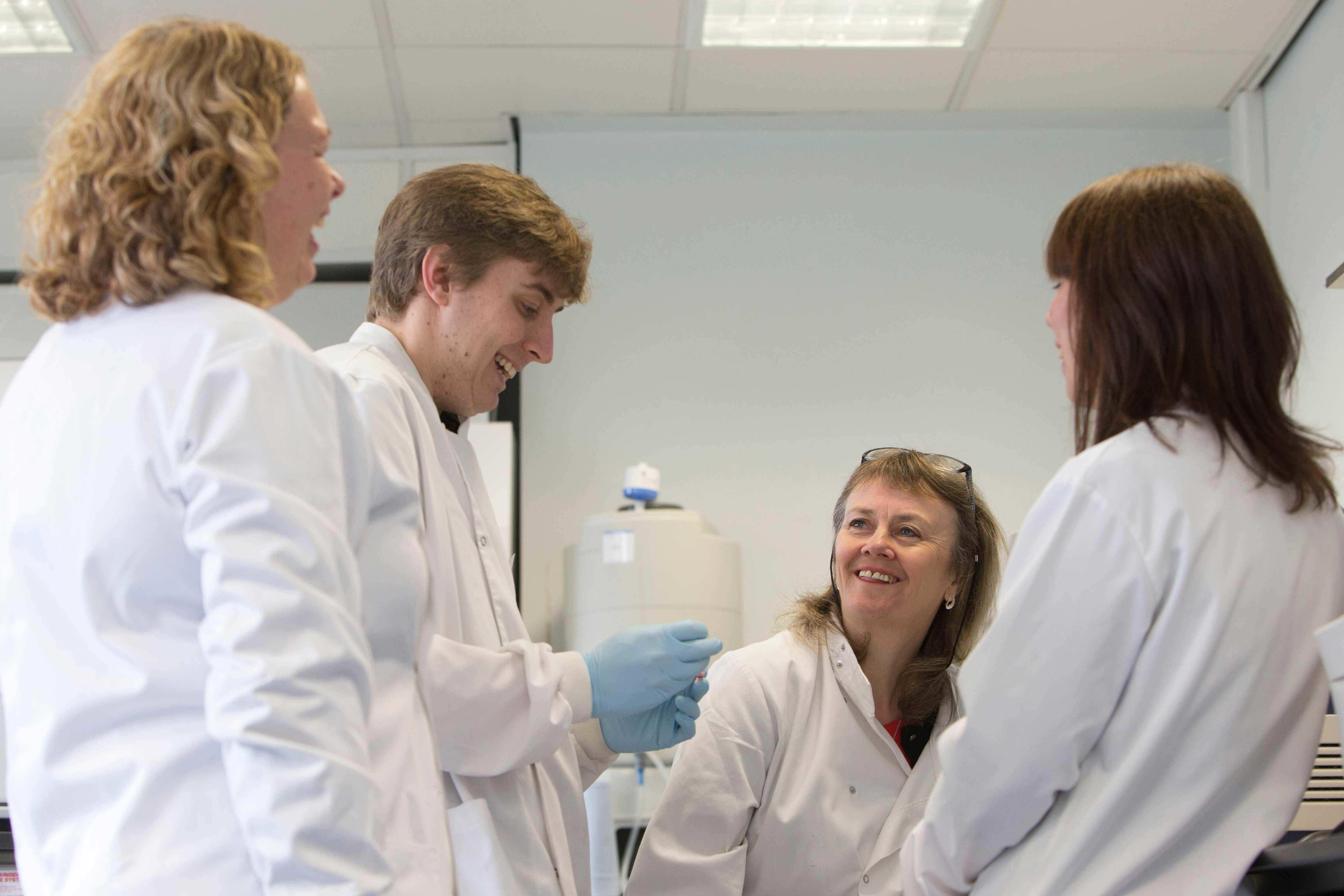 A group of scientists talking in a lab