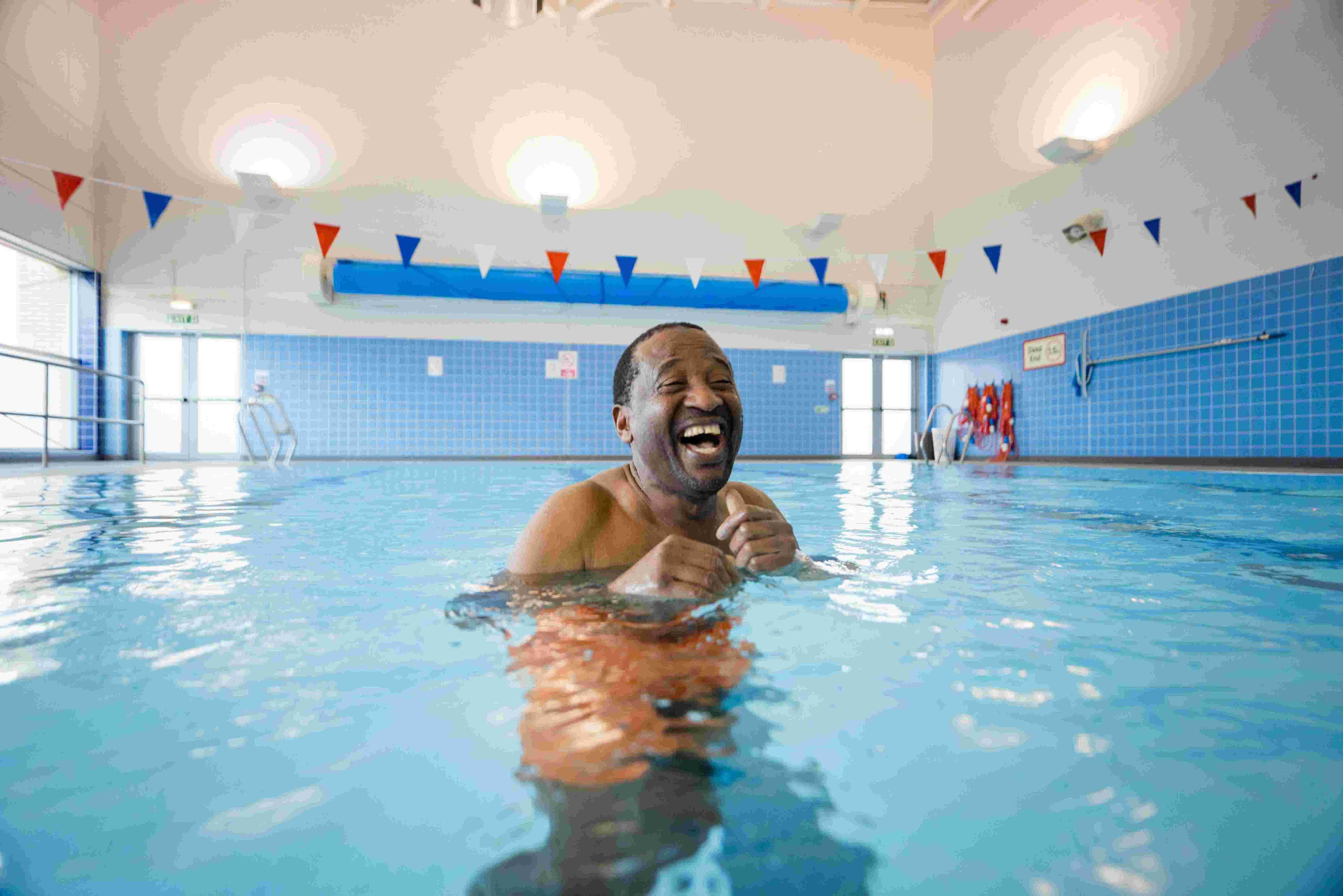 Man in swimming pool with bunting