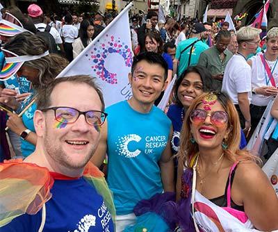 A photo of a group of people wearing CRUK t-shirts and looking happy at London Pride 2023