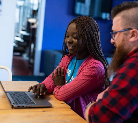 A man and woman using a laptop