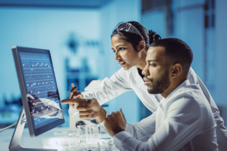 Image of 2 researchers looking at the computer screen