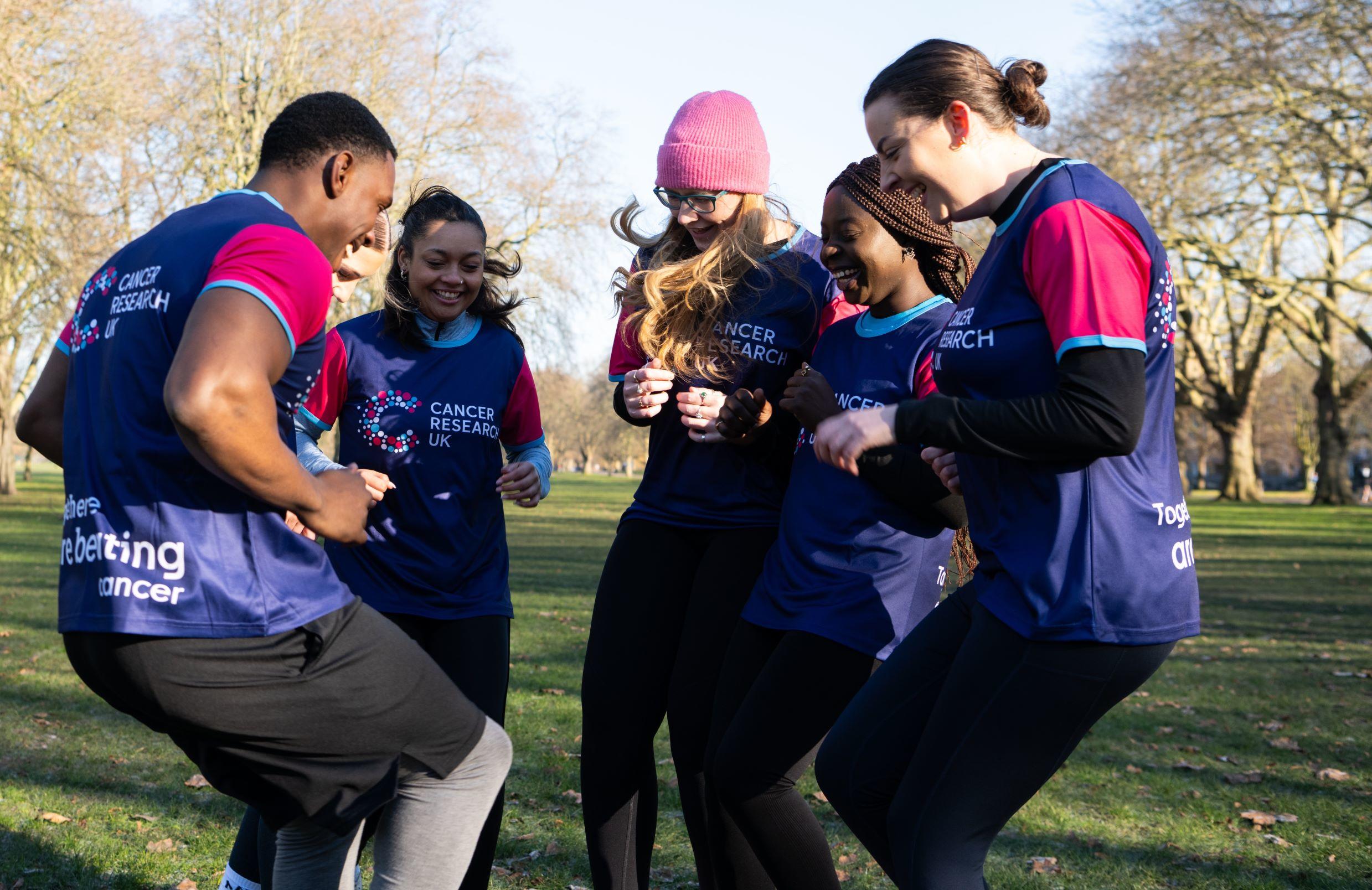 Group smiling participating in a group fundraising activities