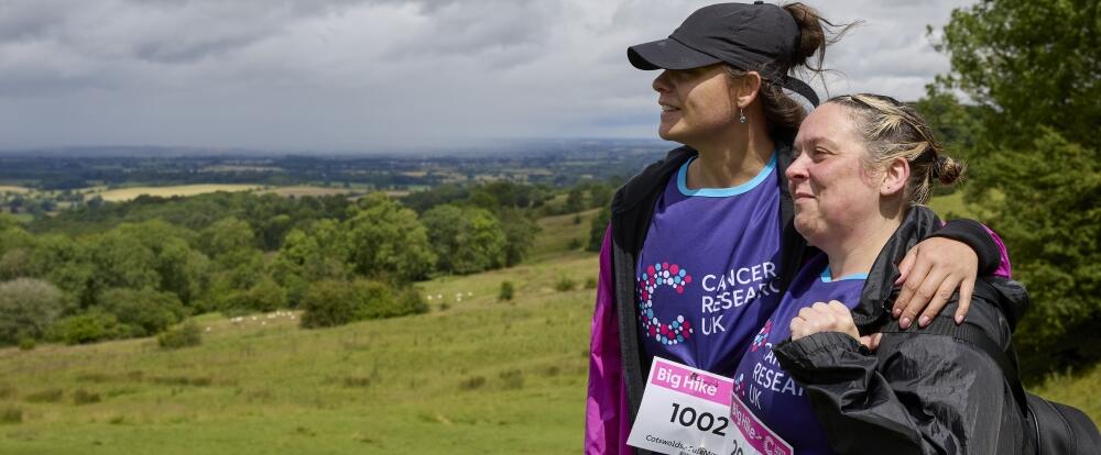2 Big Hike participants hugging and looking at the horizon