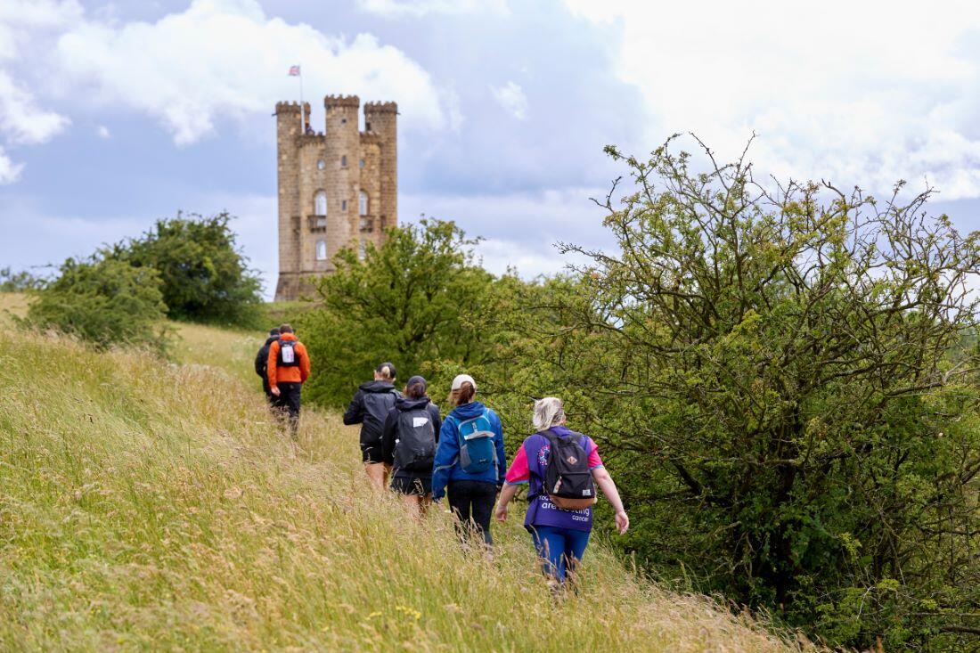 hikers heading towards Broadway tower in the Cotswolds