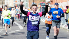 Runner with arms up at race event