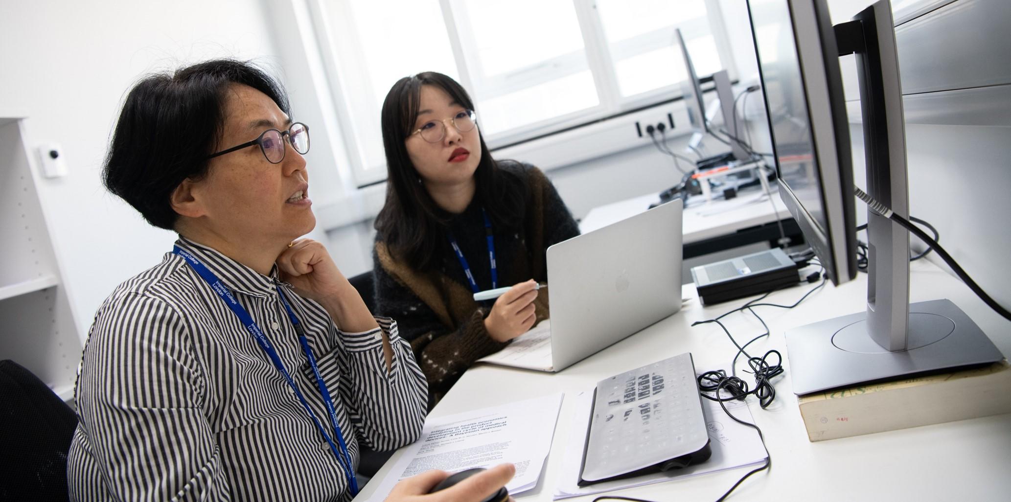 Researchers sat at a computer