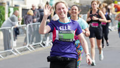 Woman running in a CRUK top