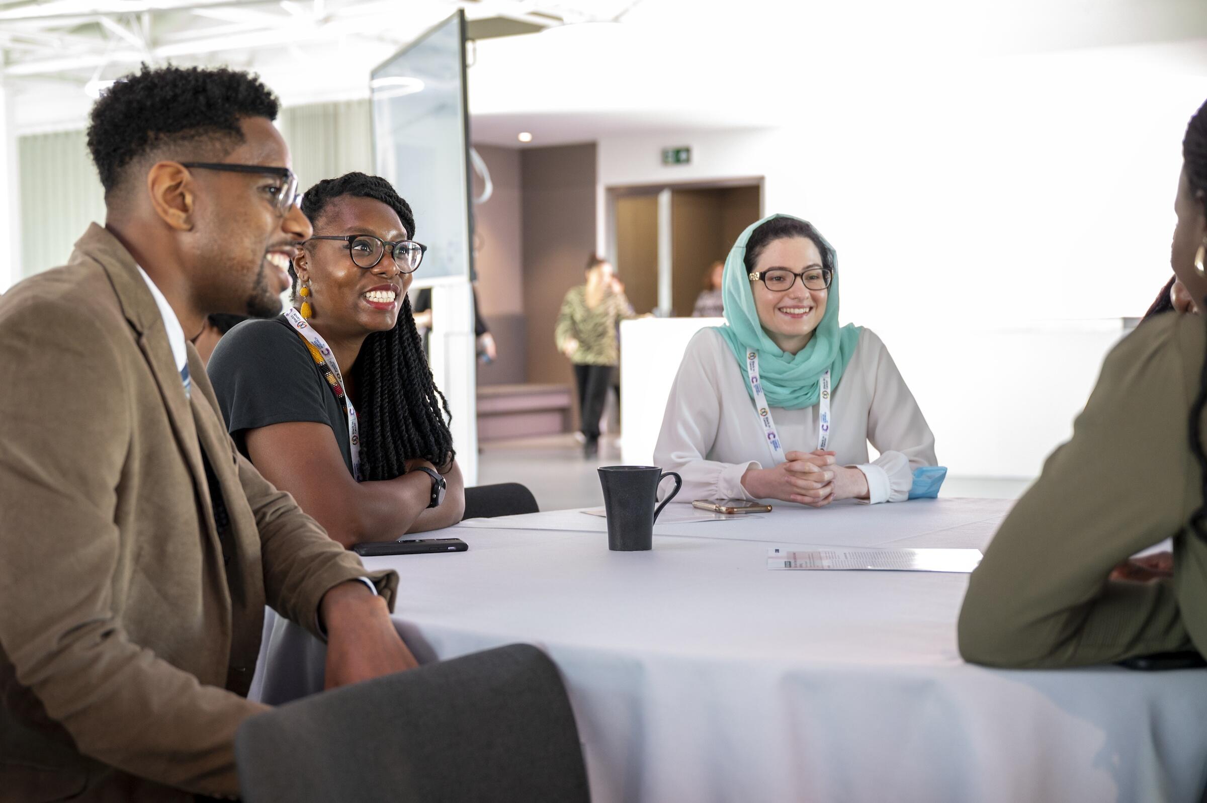 Researchers around a table having a discussion 