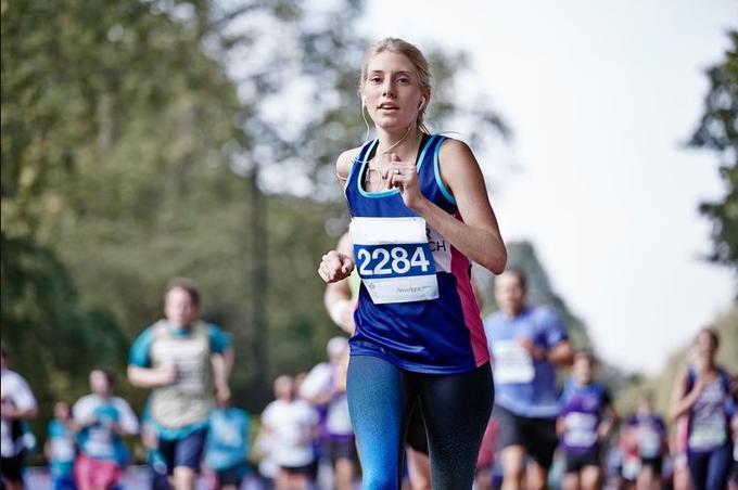 A female runner with CRUK sponsored gear