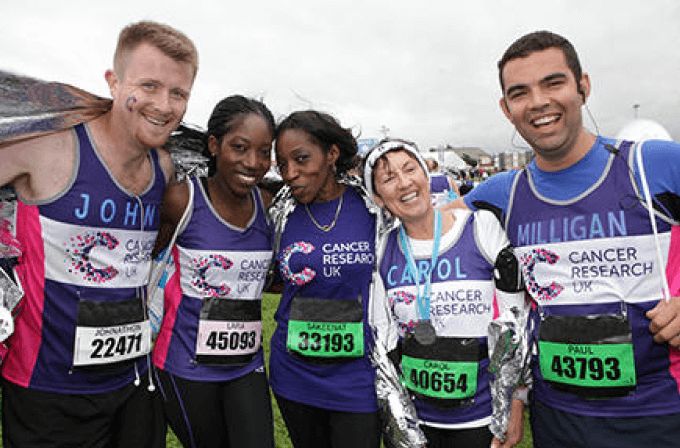 A group of runners in CRUK branded sponsorship gear