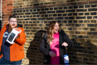 Two volunteers collecting funds outside