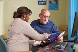 a doctor showing a patient a leaflet