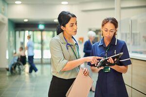 A photo of two health professionals talking