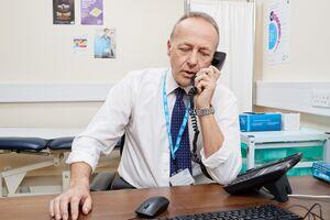 GP sat at his desk talking on the phone. GP sat at his desk talking on the phone.