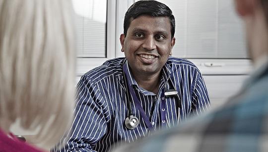 Male Asian doctor with patients