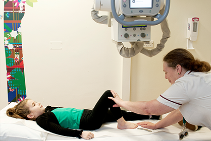 A photo of a child getting examined by a nurse
