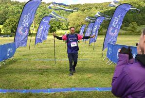 man celebrating crossing a Big Hike finish line