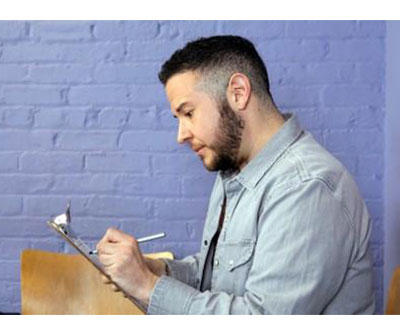 A photo of a person writing on a paper 