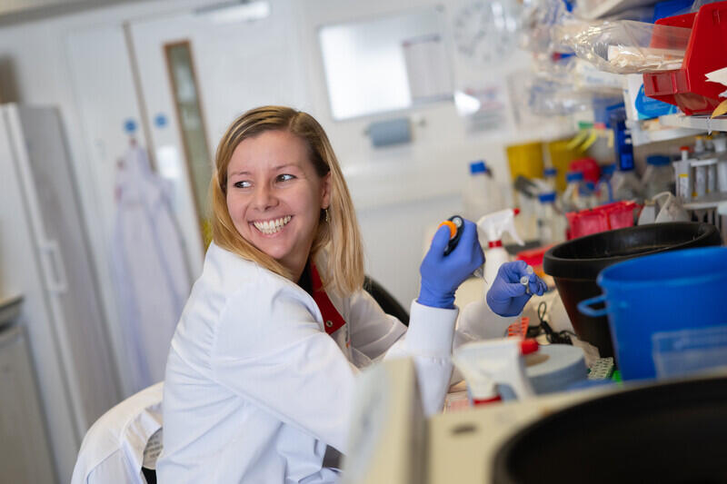 Image of female scientist smiling in a laboratory