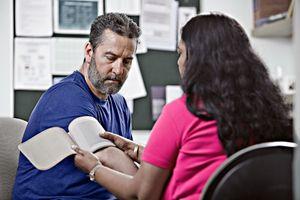 Dr with patient taking blood pressure 