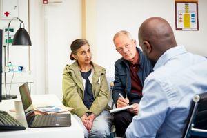 Dr talking to patient and partner 