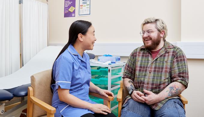 Nurse speaking to a transgender male patient about cervical screening Nurse speaking to a transgender male patient about cervical screening